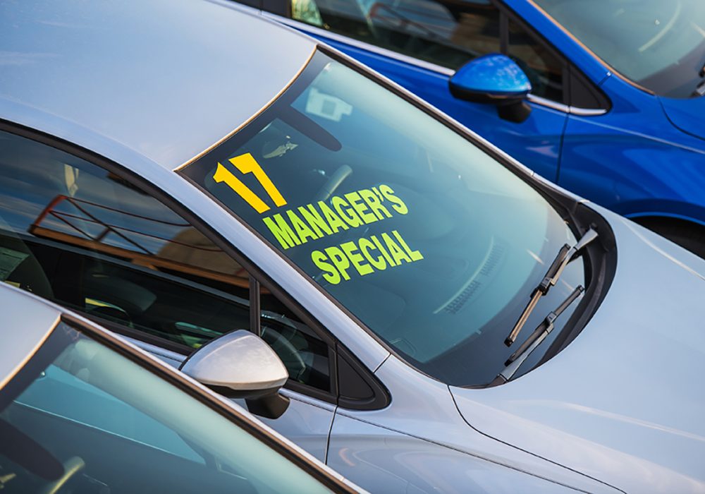Brand New Vehicle with Managers Special Sign on a Windshield. Car Dealer Lot.